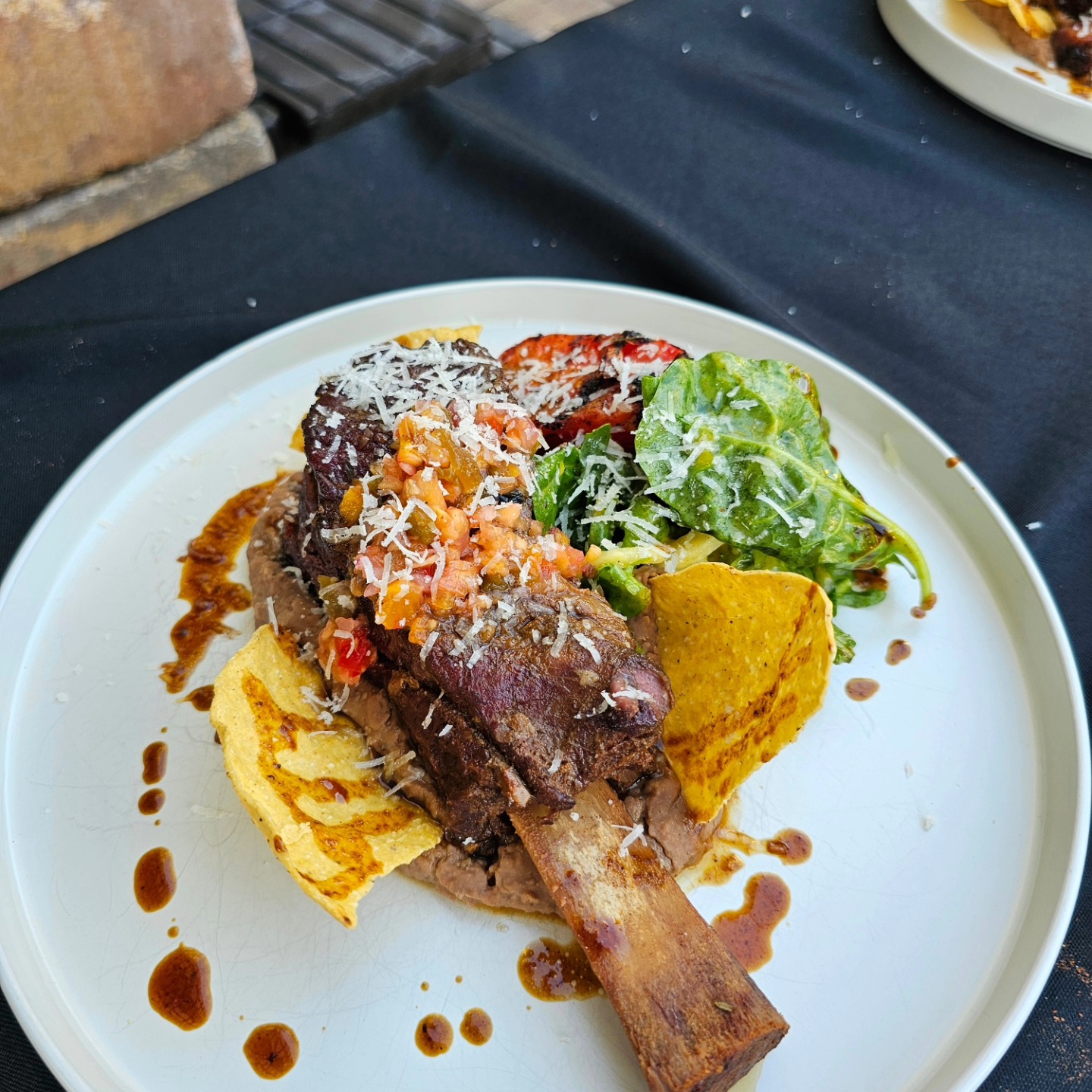 Elegant plated short rib with tortilla chips and greens - Chef Pete Jacksonville